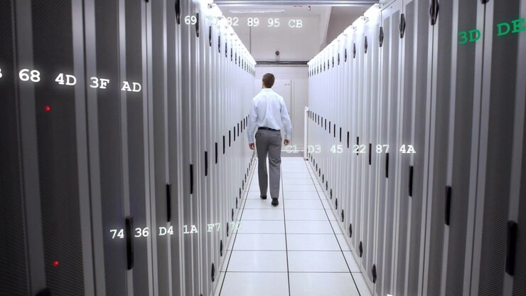 IT engineer walking data center aisle after alert, inspecting and monitoring hex overlays on racks