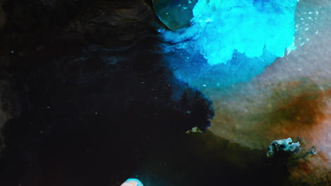 fusion of turquoise blue color ink with black ink in liquid media