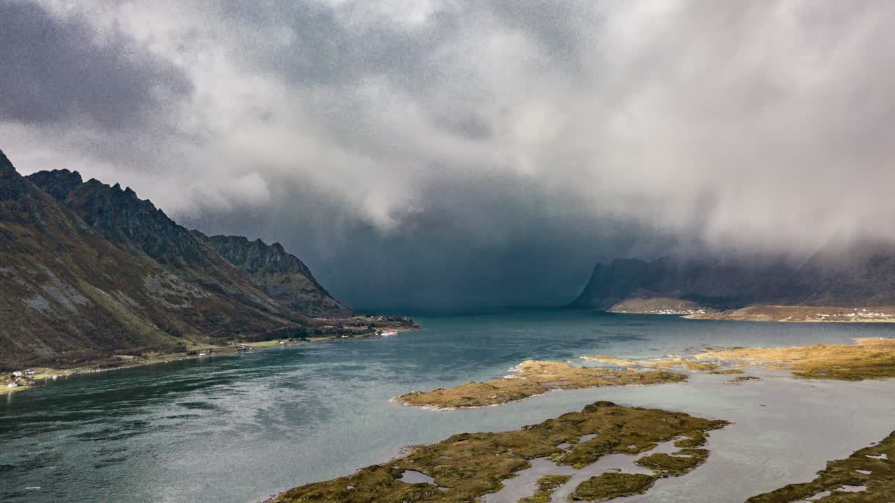 A Thick Mass Of Clouds Forming And Whirling Above Dark Blue Waters Of Grimsoystraumen Strait