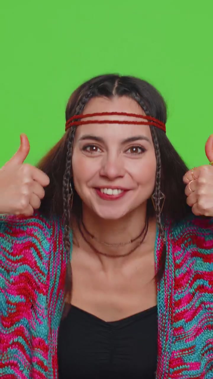Young woman raises thumbs up agrees or gives positive reply recommends advertisement likes good idea