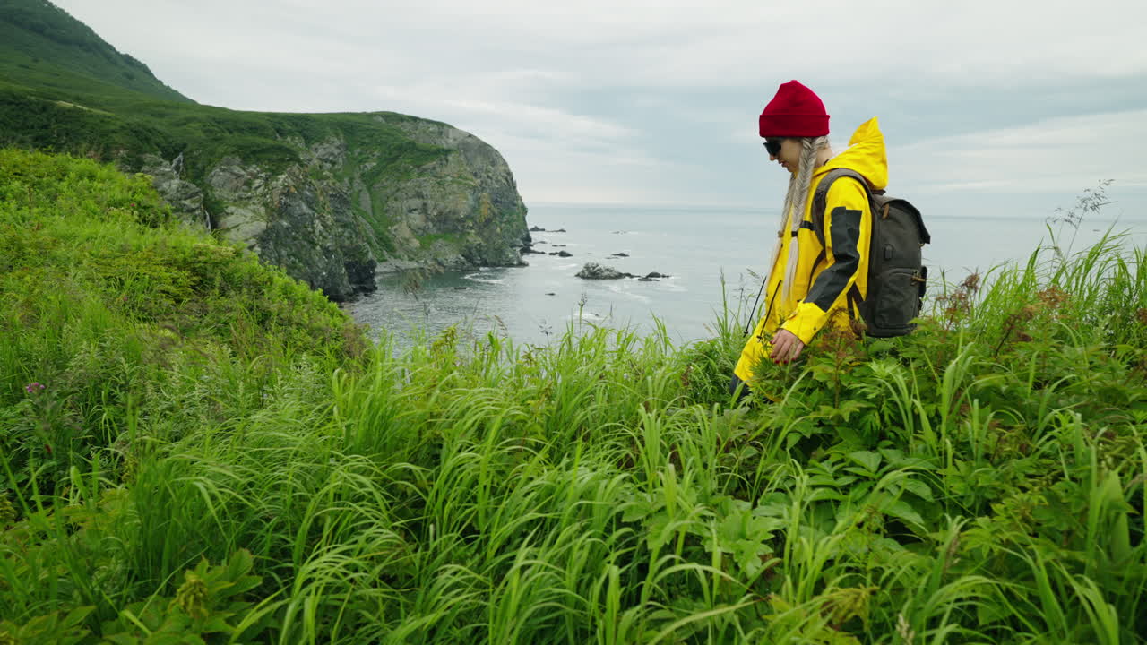 Woman Hiking Along Coastal Cliffs