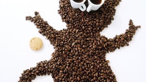 coffee beans and cups forming monkey with cookie