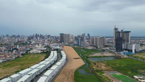 Phnom-Penh-capital-city-of-Cambodia-,-drone-approaching-the-city-hub-in-south-east-Asia