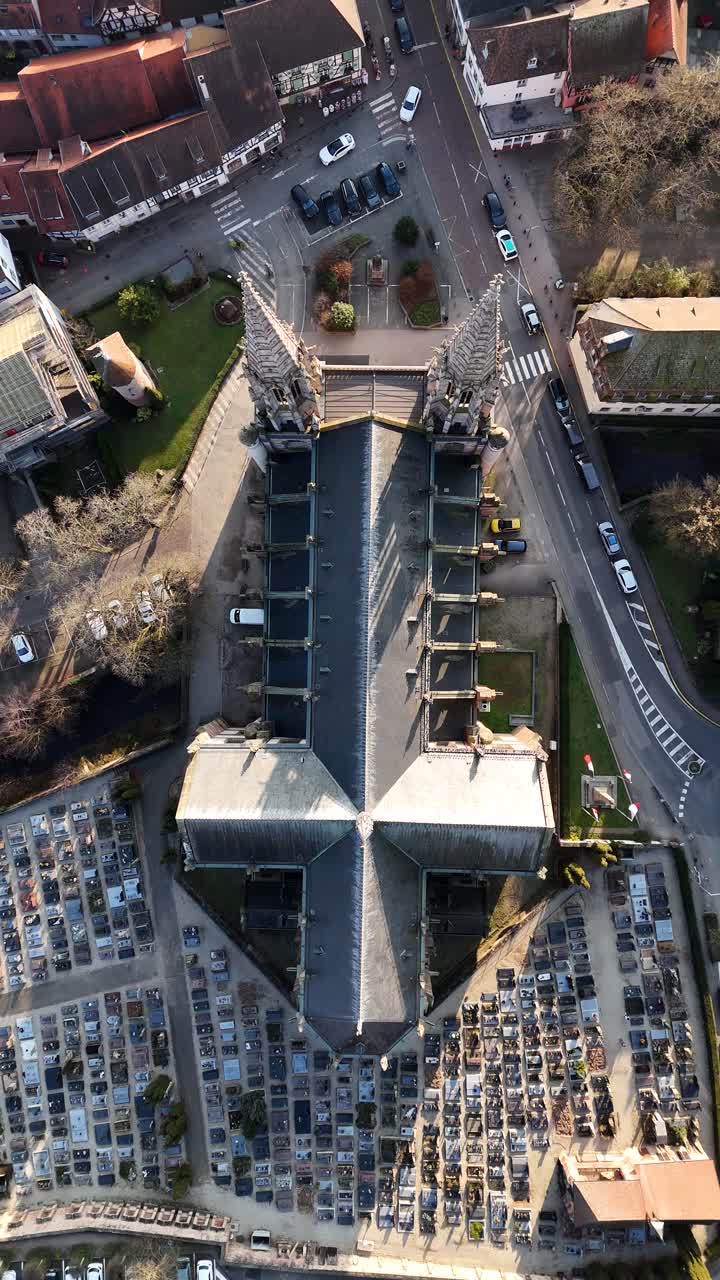 St. Peter and St. Paul's Church observed from above in Obernai, France, featuring cemetery and surrounding streets