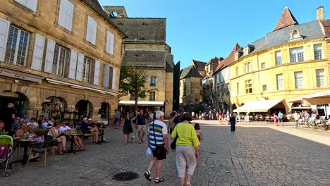 people walking and dining in a historic street