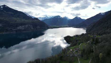 aerial view downward of vibrant mountain landscape with an alpine lake