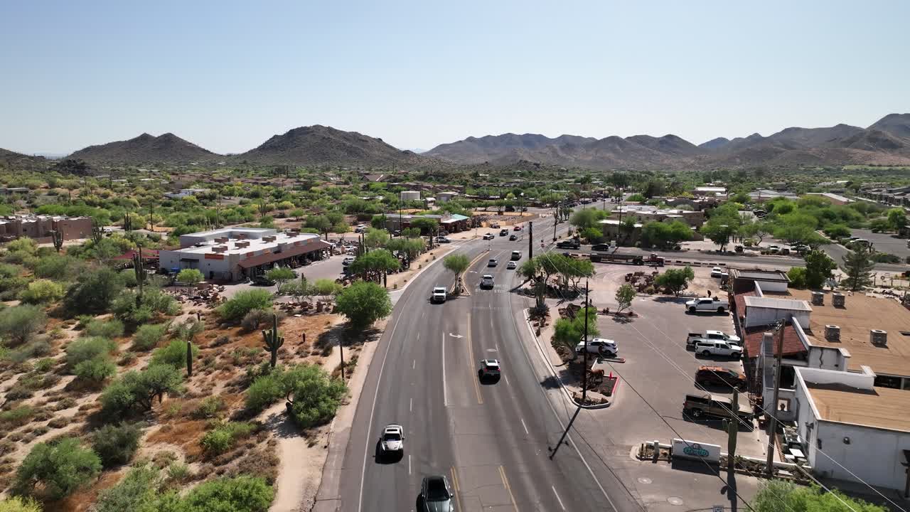 Drone shot of cars driving through Arizona's town of Cave Creek