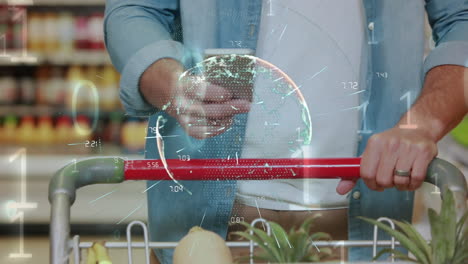 animation of globe of network of connections over man with shopping trolley using smartphone