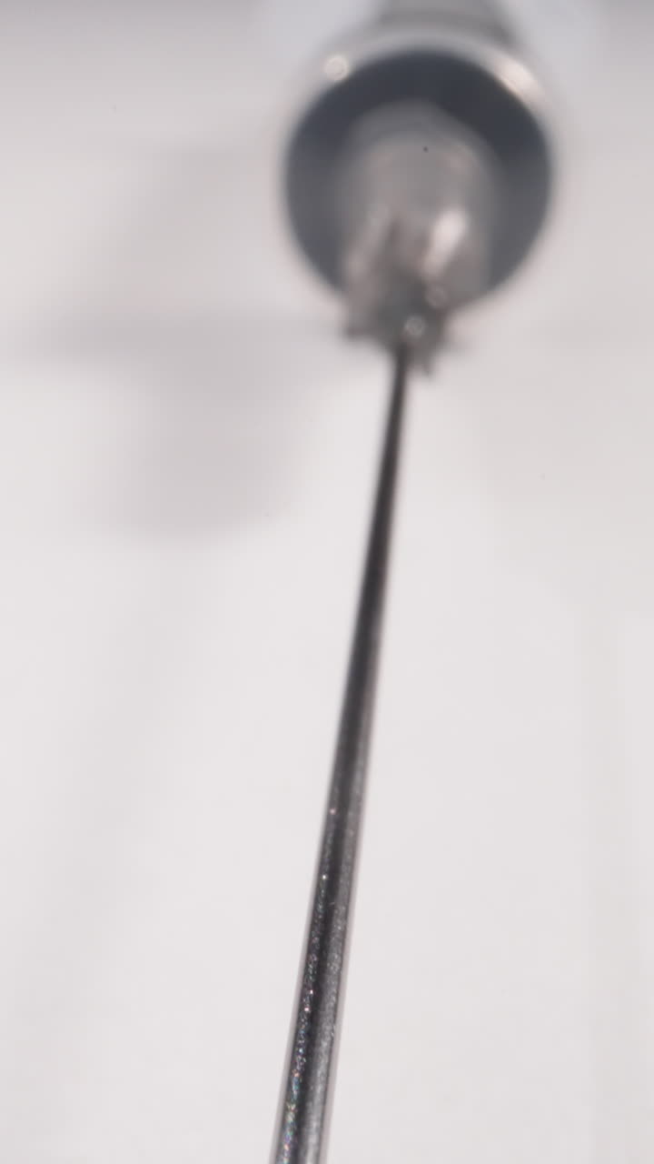 Long metal needle of syringe on white background extreme close view. Vaccination day importance. Disposable medical instrument for patient care