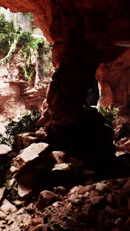 a view of a cave in a red rock canyon