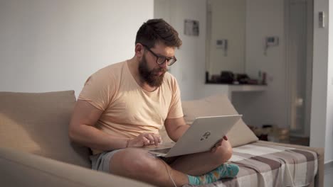 hombre trabajando en una computadora portátil en casa