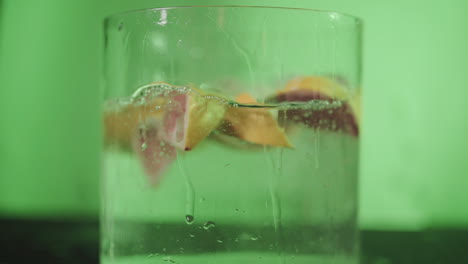 detoxing healthy grapefruit slices drop in water slow motion