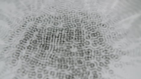 water forming micro cymatic patterns and reflecting light