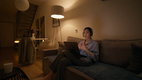 woman having a video call at home at night