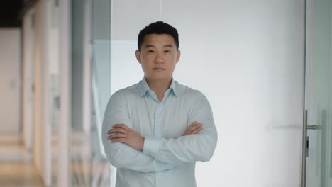 confident asian business man in office