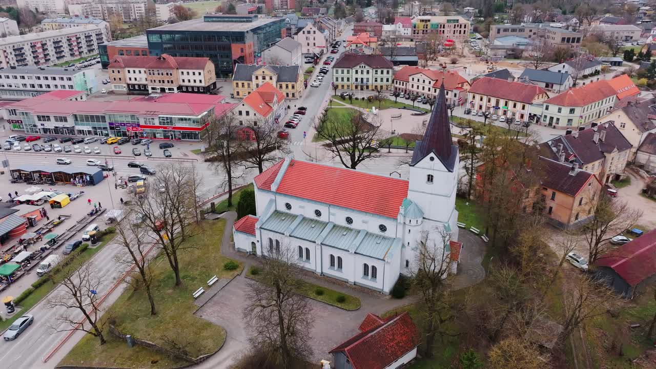 Classic Latvian church stands in Saldus old town as drone reveals urban layout