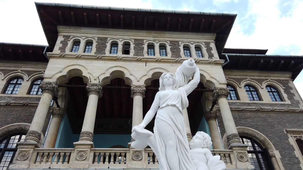 White statue in front of the Cantacuzino Castle in Busteni, Romania