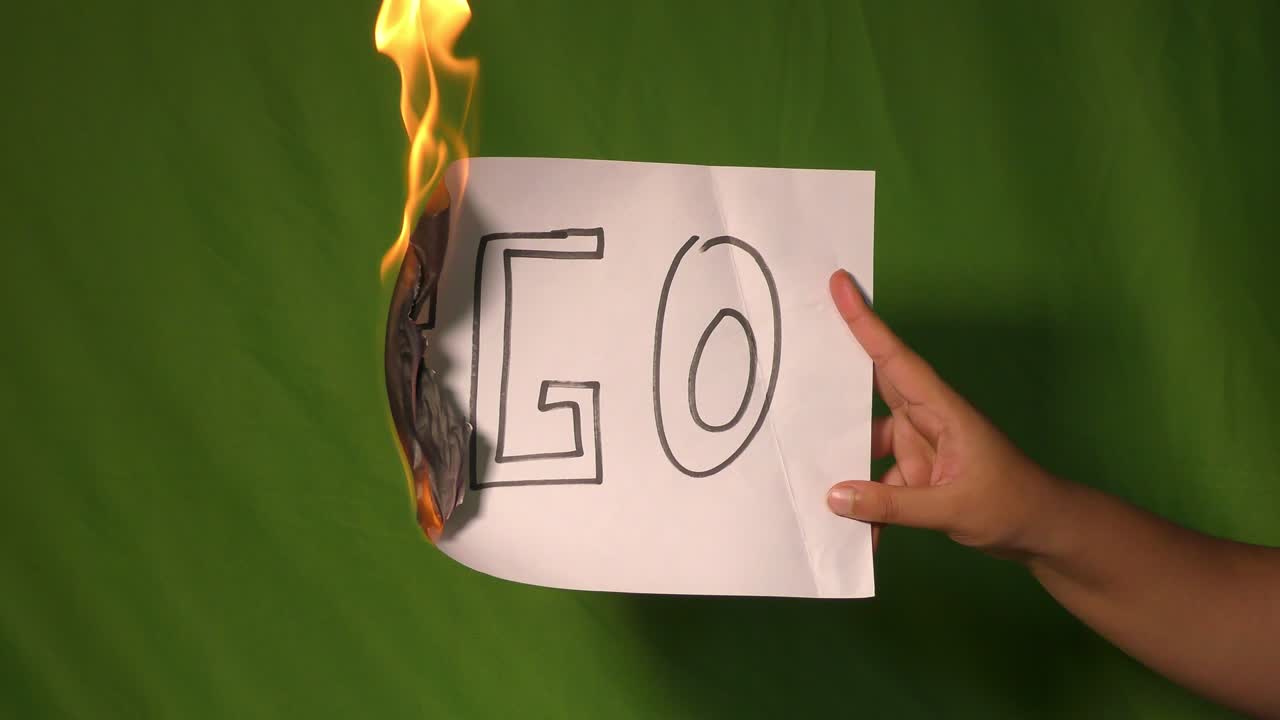 한 손은 에고 텍스트 단어가 새겨진 불타는 종이를 들고 있습니다.