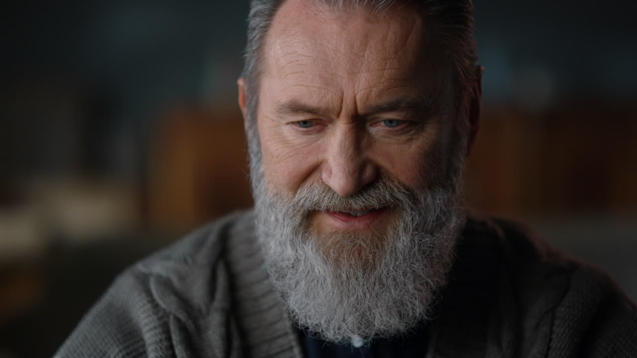 Elderly man getting information at home. Greyhaired man working remotely indoors