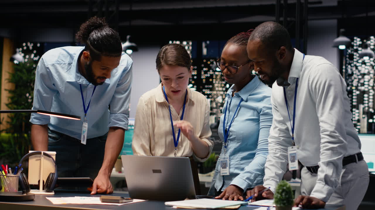 Portrait of associates team collaborating in office environment at night
