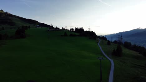 Meadow-with-village-and-mountain-range