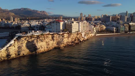 Hotels-and-resorts-in-Benidorm,-Spain---aerial-parallax-panorama-and-view-of-Puig-Campana-Mountain