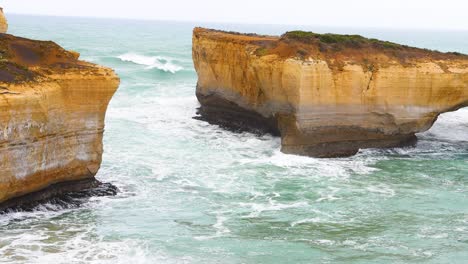 stunning coastal cliffs and turquoise waves under soft daylight at port campbell, vic, australia. captured in a serene, natural setting
