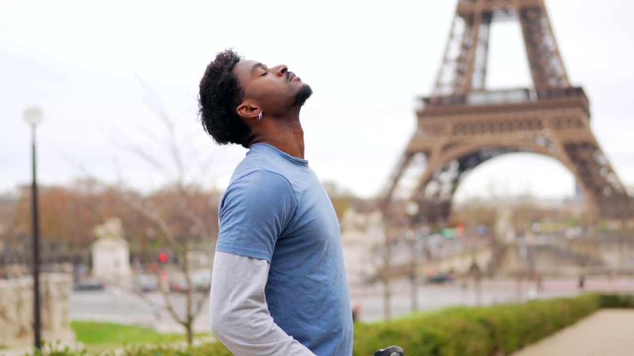 Man drinking water with Eiffel Tower in background