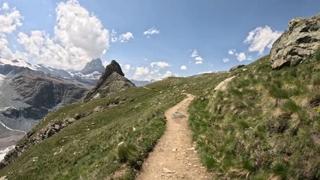 walk towards matterhorn mountain surrounded by swiss alps, trekking on a beautiful sunny day