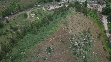 drone flight over large mountains revealing small town