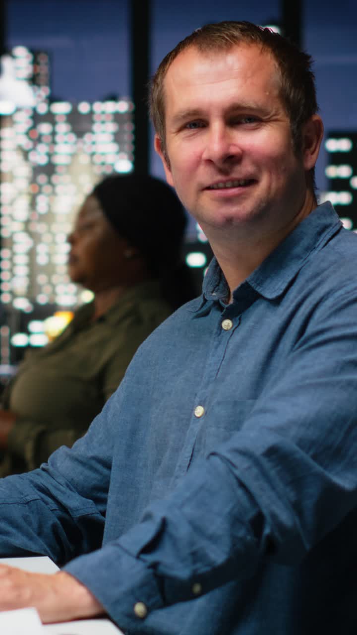 Vertical Video Portrait of male engineer uses architectural software and blueprints