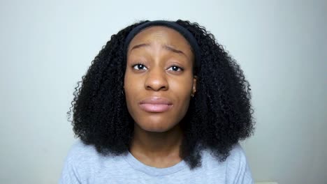 young student looking visibly concerned while talking to camera on video call