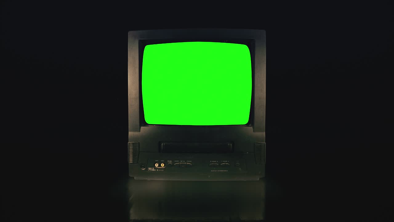 Vintage TV Green Screen in a dark room. Retro Television turning on with Noise and Static.