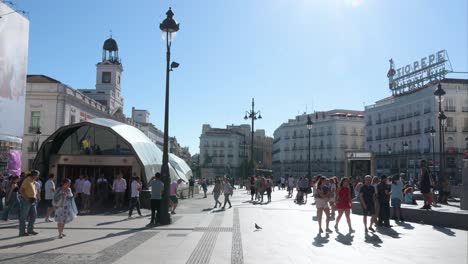 bustling puerta del sol in madrid on a sunny day