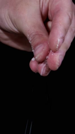 a person is holding a piece of paper in their hand. the person’s gesture reveals a piece of paper held between their fingers and thumb, resembling an animal product, against their flesh