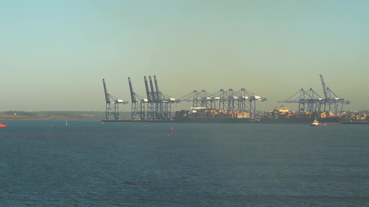 Container cranes at Felixstowe Port. Smog and pollution from ships