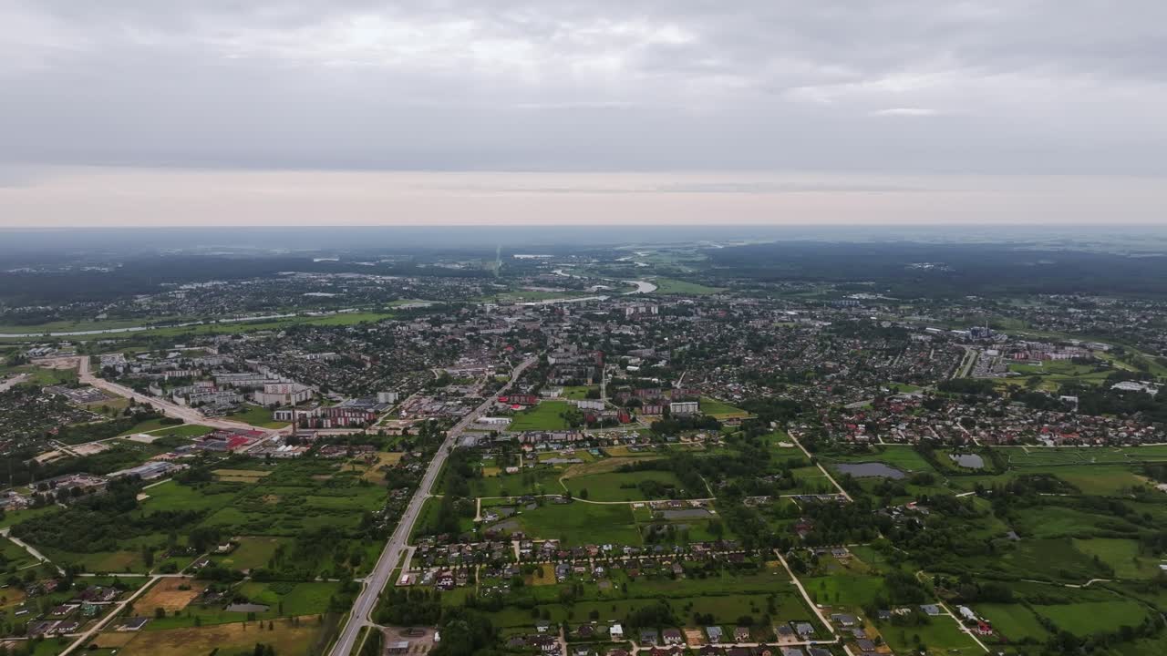 Rightward aerial slide over Jelgava during cloudy summer morning in Latvia