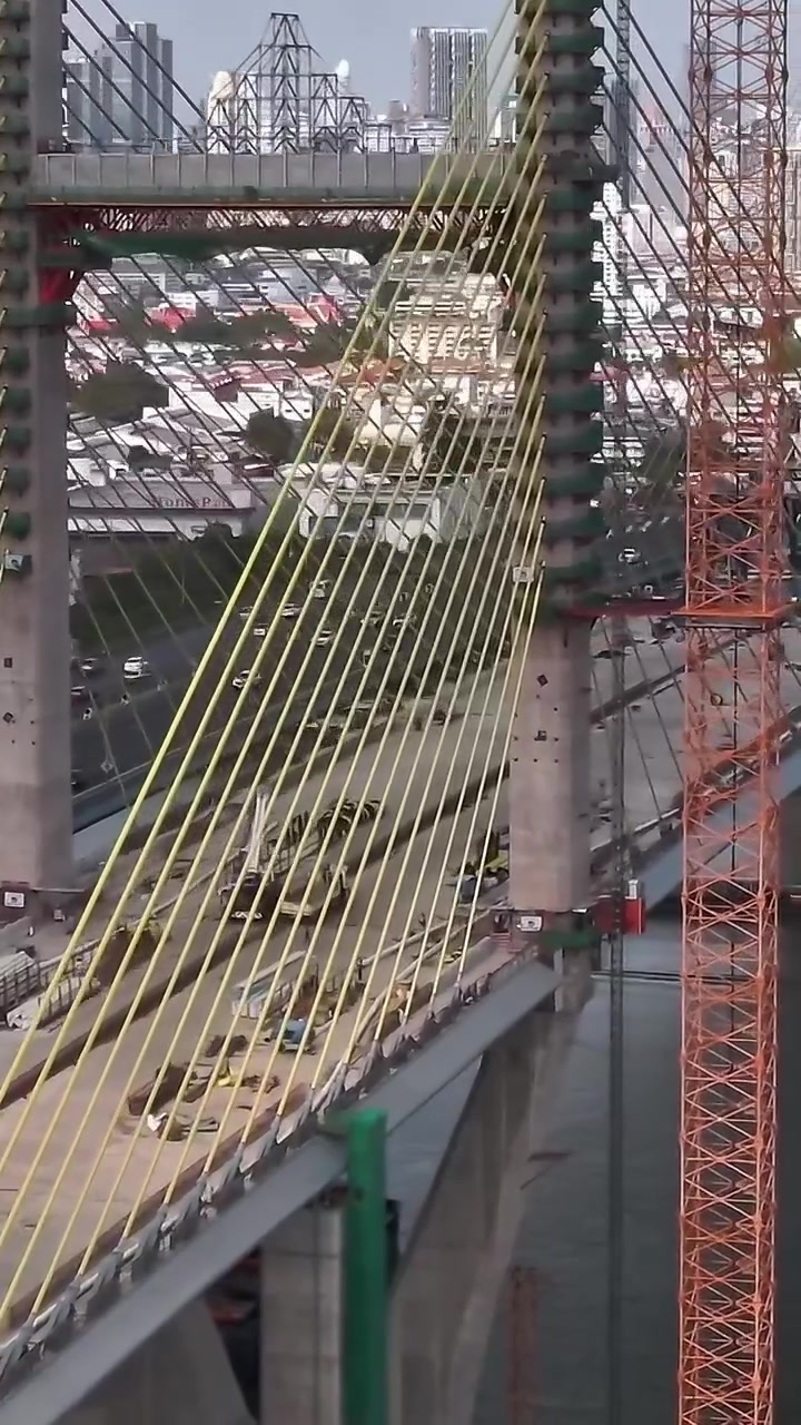 Construction of new bridge in Bangkok over river with city skyline