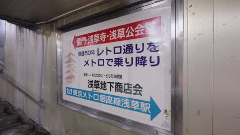 a retro-style sign at asakusa station directs people to the underground shopping arcade and nearby attractions