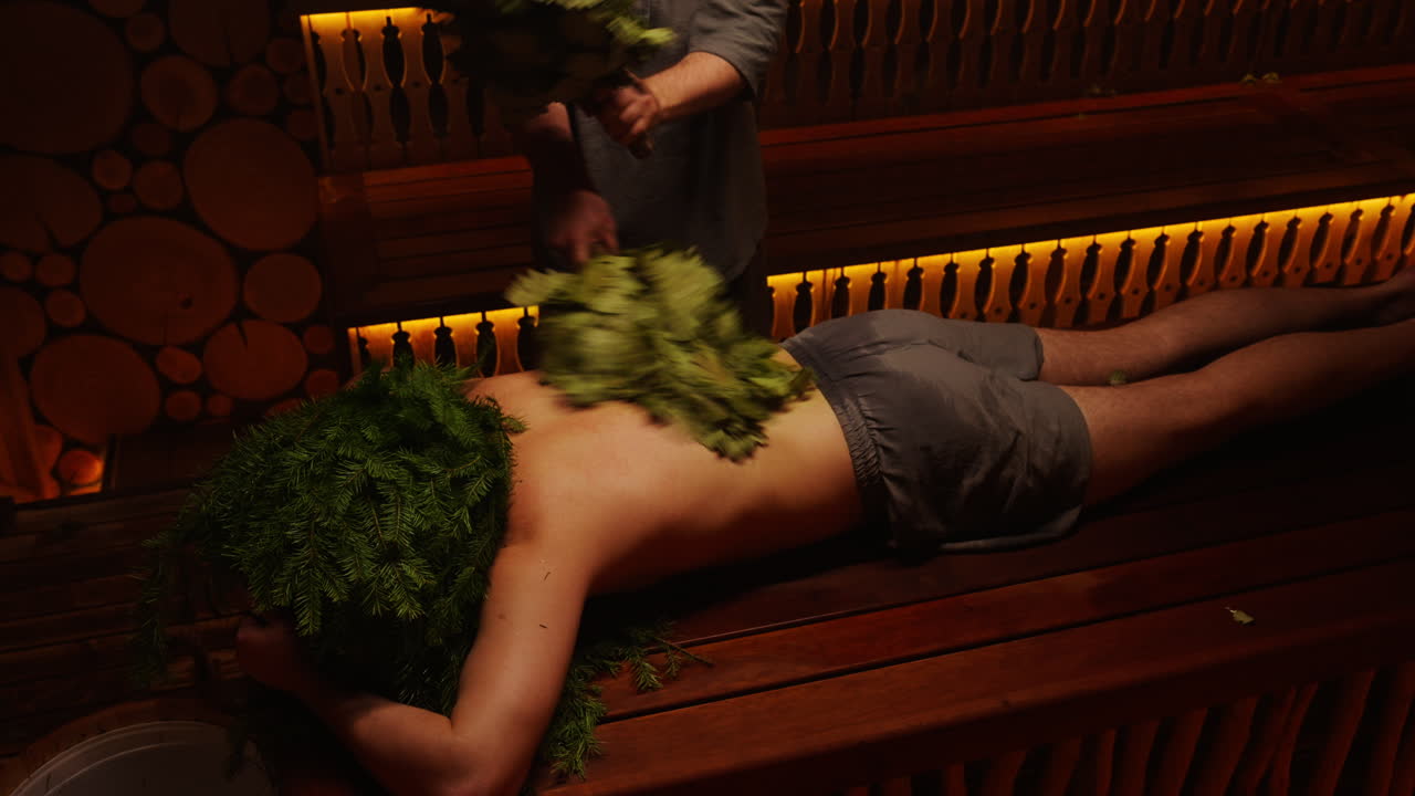 Person receiving herbal steam treatment in a sauna