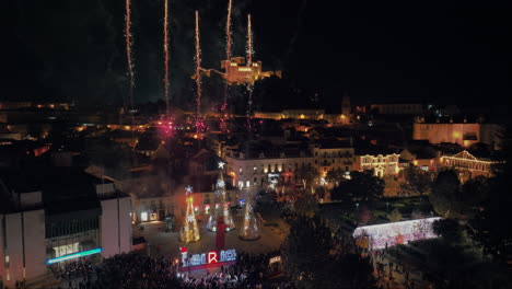 aerial view of fireworks in a portuguese town full of people