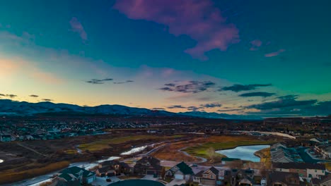 sunset over a golf course in a valley community - aerial time lapse hyper lapse