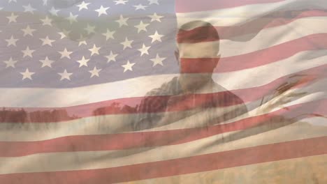 Animation-of-flag-of-america-blowing-over-male-farmer-standing-in-field-of-wheat