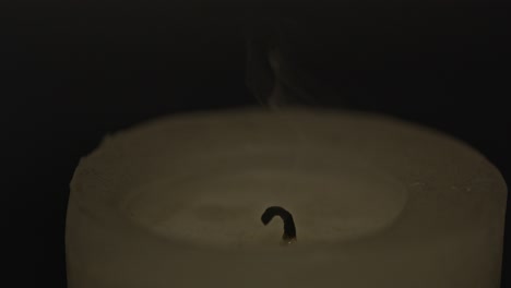 close up of a candle being blown out in slow motion