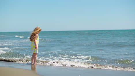 a little girl playing on the beach