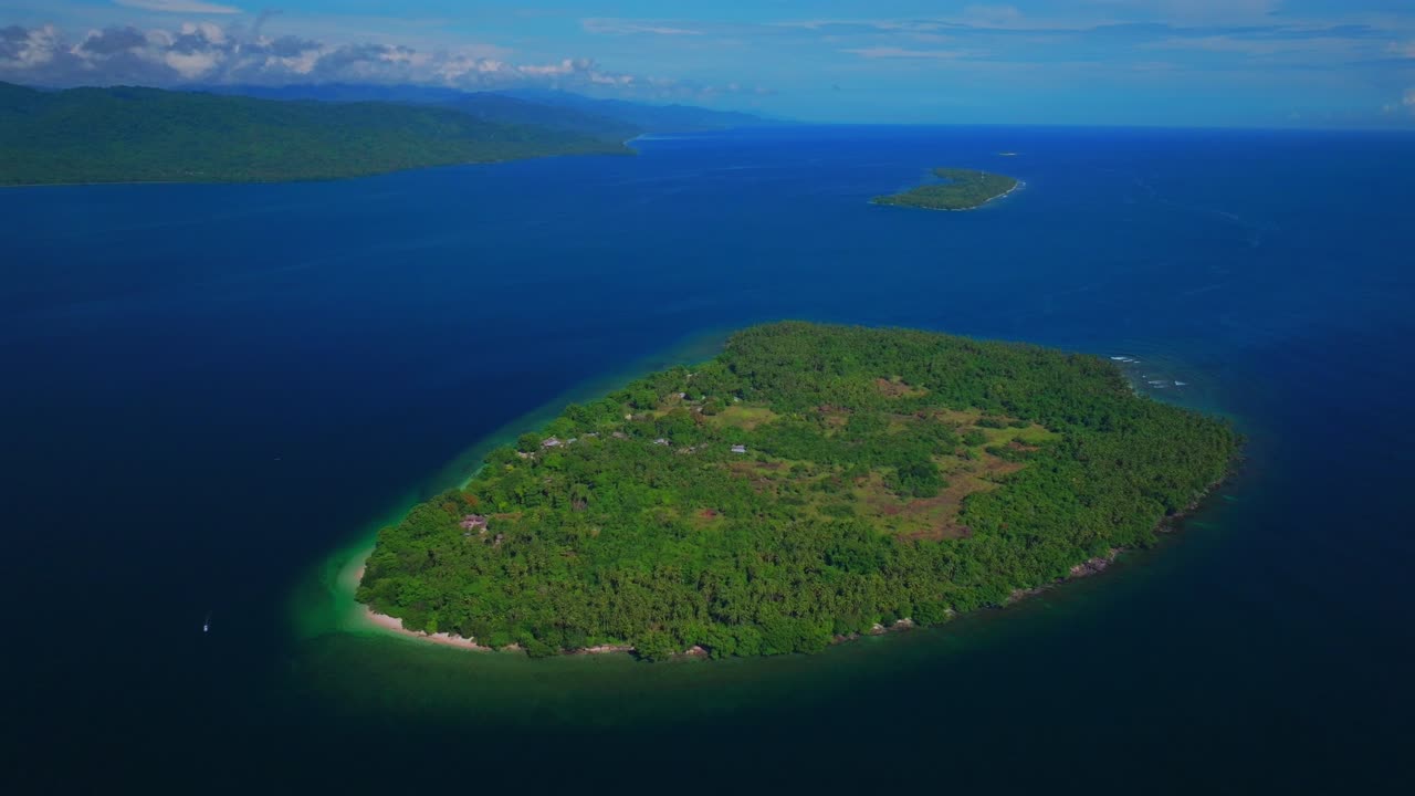 Yuo Island remote pristine untouched tropical Mushi island coastline village Wewak Madang Cape Wom Papua New Guinea aerial drone PNG dry season summer morning bleu sky power fishing boat circle left