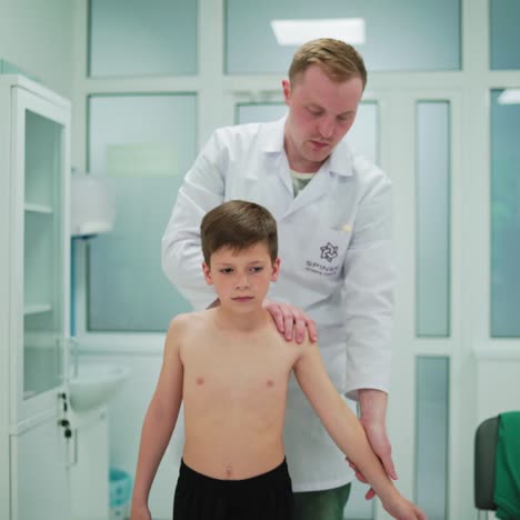 physical therapist assisting little boy