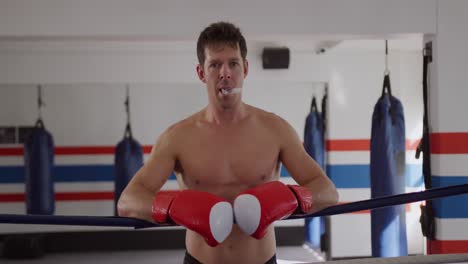 caucasian man standing in boxing ring