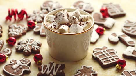 cup of hot chocolate and christmas shaped gingerbread cookies