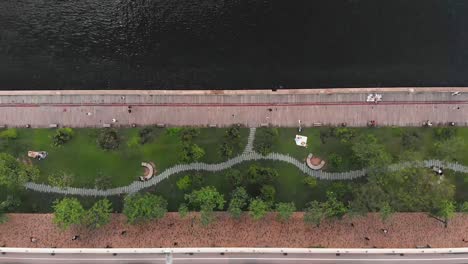 aerial drone bird eye view of the highway next to the park and sea.